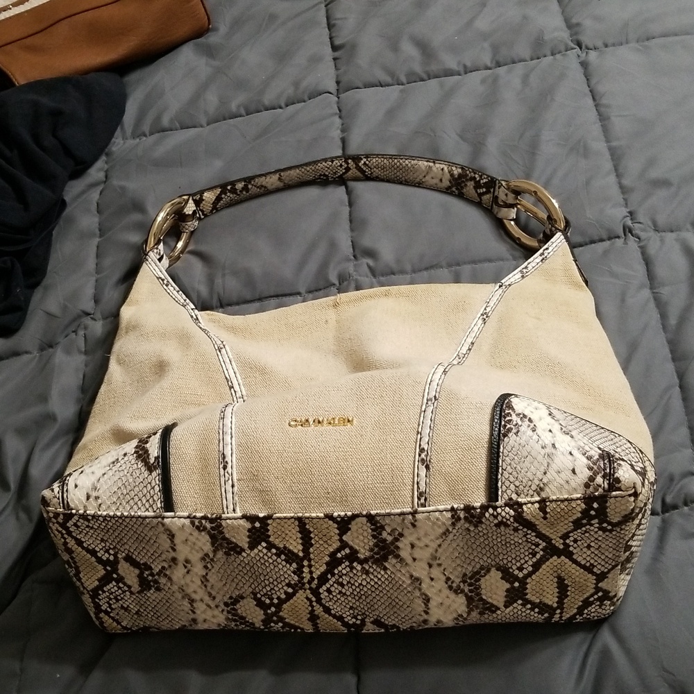 Calvin Klein snakeskin pocketbook. Zipper compartment and fairly big inside